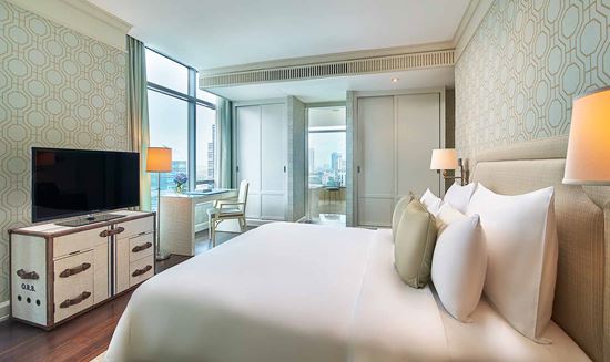 King-sized bed in master bedroom in Two Bedroom Suite